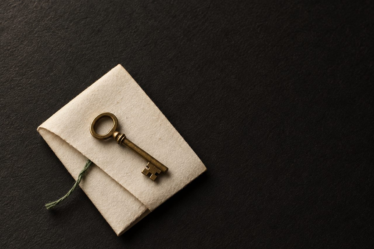 A single hand-stamped cream dot on black paper